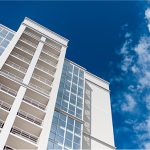 A tall white building with a sky background