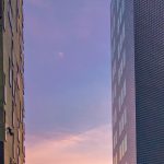 A view of two buildings from the ground up.