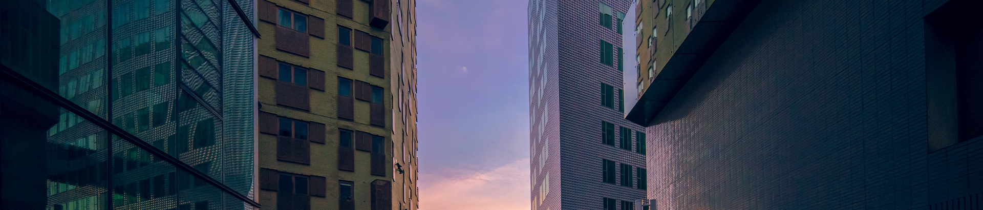 A view of two buildings from the ground up.