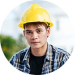 A man wearing a yellow hard hat and plaid shirt.