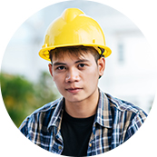 A man wearing a yellow hard hat and plaid shirt.