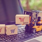 A forklift is carrying boxes on top of the keyboard.