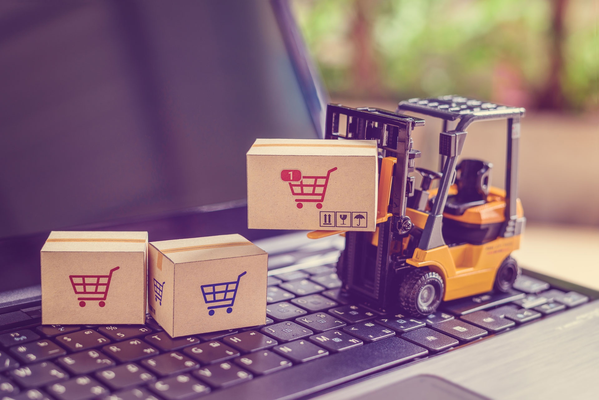 A forklift is carrying boxes on top of the keyboard.